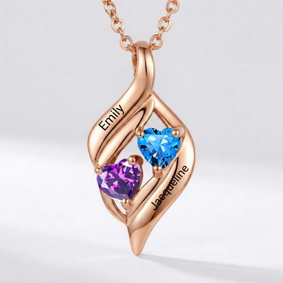 Sterling silver rose gold plated heart pendant with two names and red stones.
