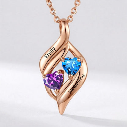 Sterling silver rose gold plated heart pendant with two names and red stones.