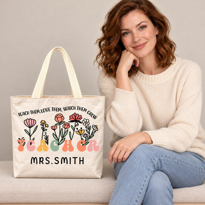 Personalized teacher tote with floral teacher artwork with the phrase TEACH THEM, LOVE THEM, WATCH THEM GROW and custom name MRS.SMITH, custom name detail view.