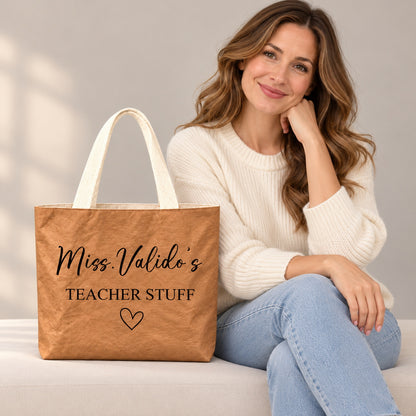 Personalized teacher tote with TEACHER STUFF lettering and an outlined heart and custom name Miss.Valido's, custom name detail view.