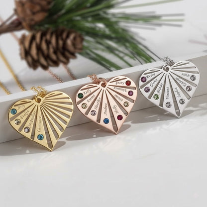 Three personalized heart necklaces in gold, rose gold, and silver, each with custom names and multiple birthstones.