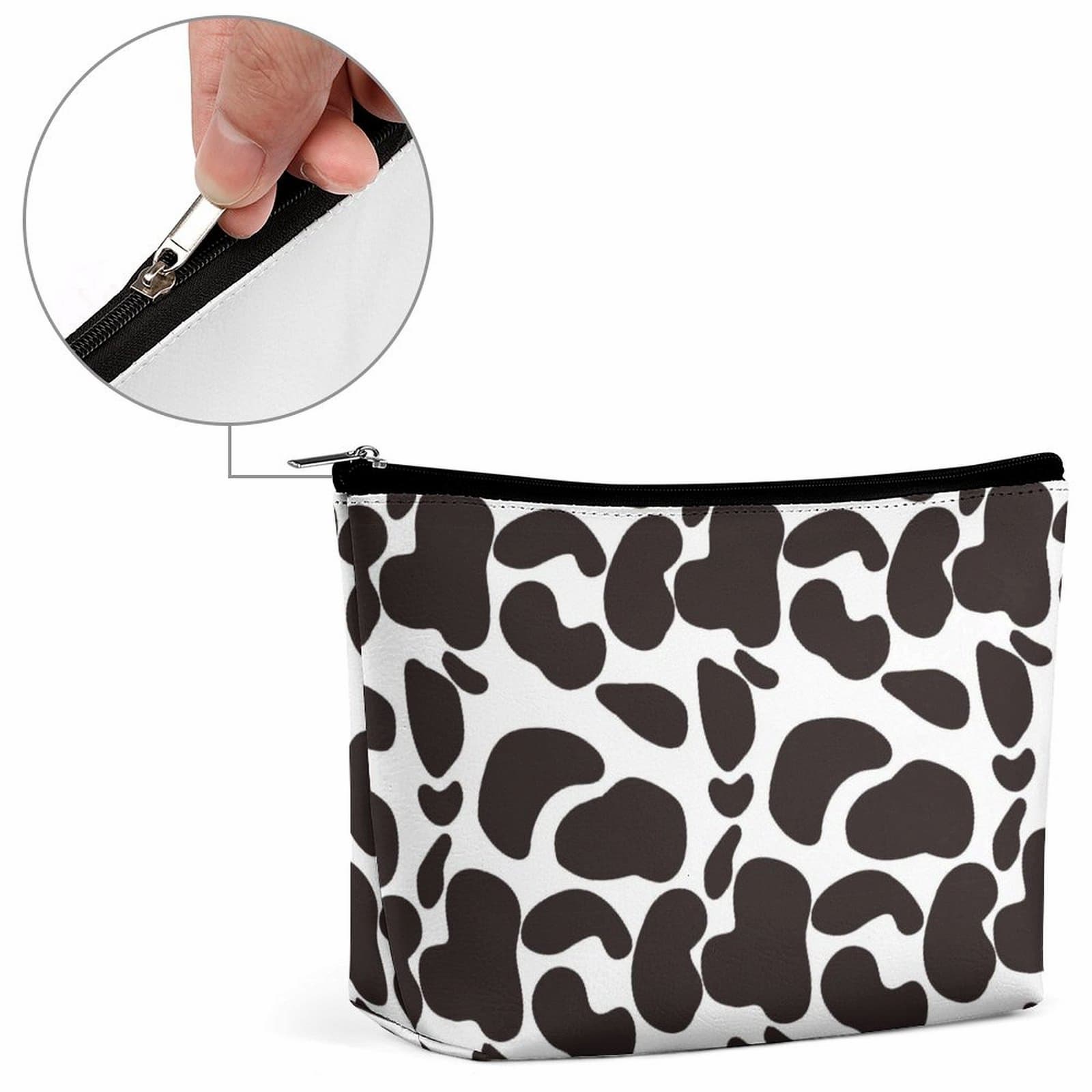 Detail of the durable metal zipper on the Travel Makeup Bag in popular cow print.