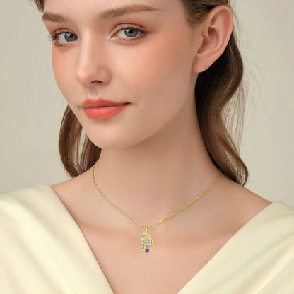 Woman wearing gold personalized birthstone name necklace with 3 custom names.