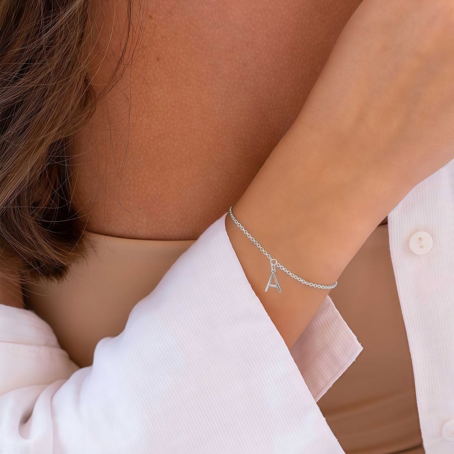 Woman wearing Sterling Silver Initial Letter Bracelet. Custom Gold Plated Jewelry.
