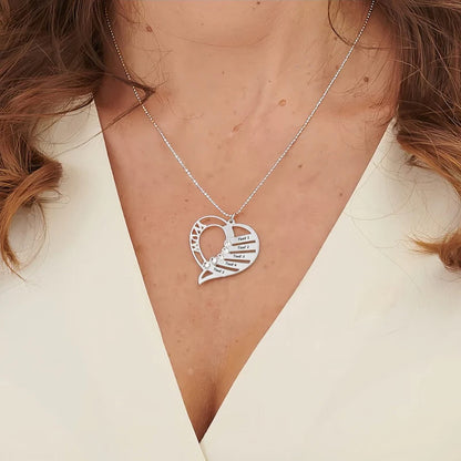 Woman wearing personalized heart family name necklace in sterling silver, Mother's Day gift.