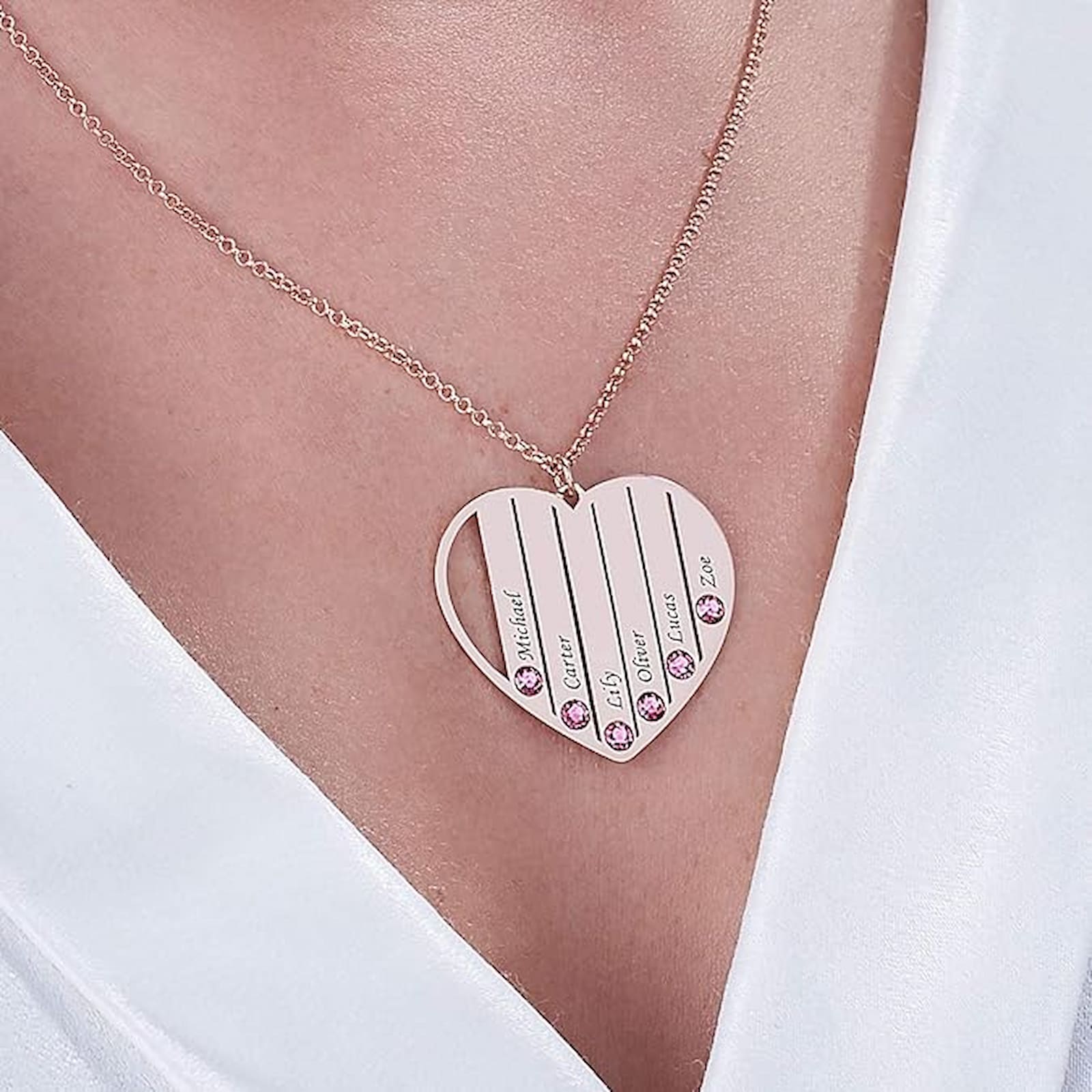Woman wearing rose gold custom family birthstone necklace with kids names.