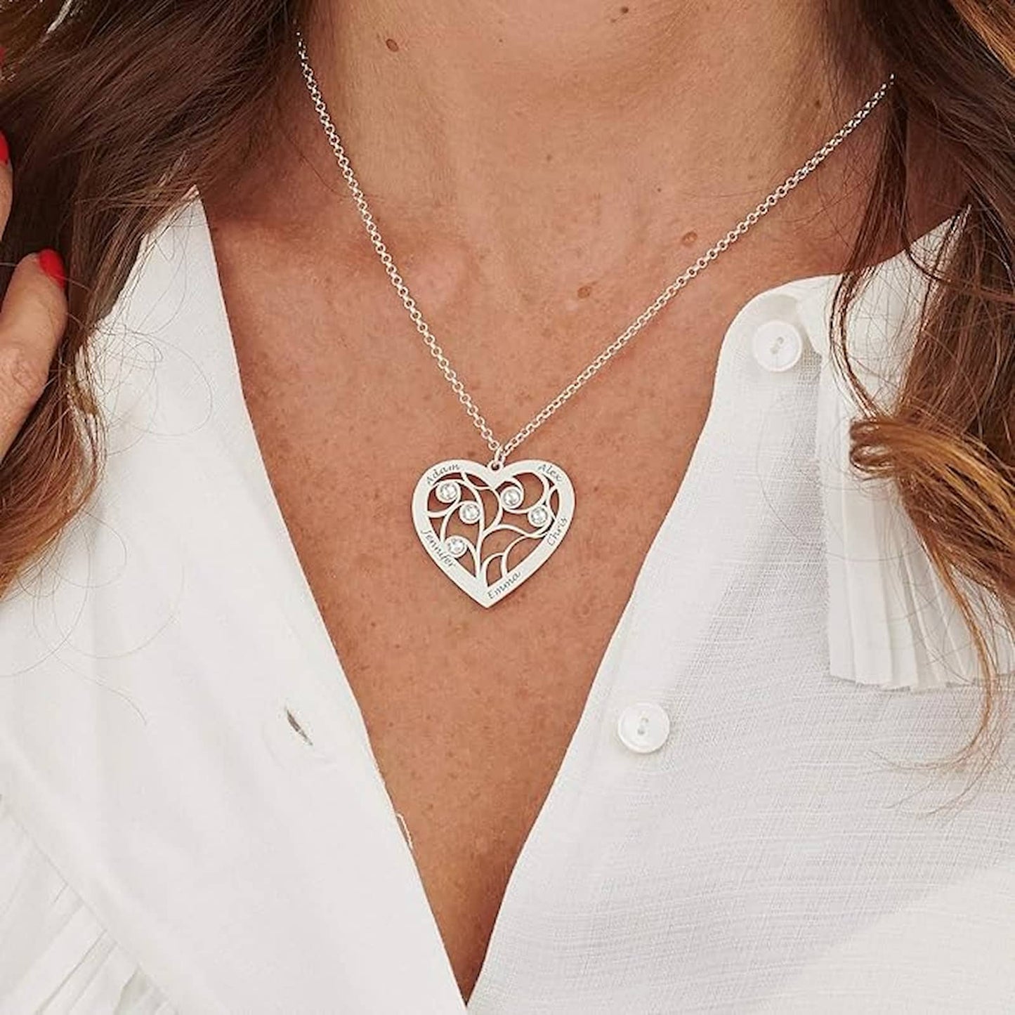 Woman wearing gold personalized family tree birthstone necklace with custom names.