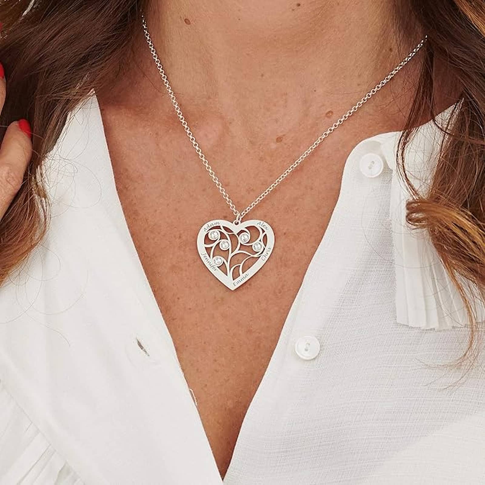 Woman wearing gold personalized family tree birthstone necklace with custom names.