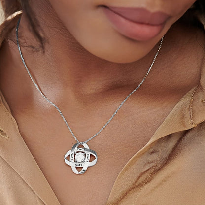 Woman wearing silver engraved Love Knot birthstone necklace, perfect anniversary gift.