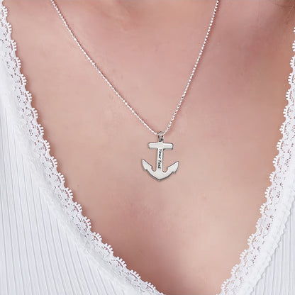 Woman wearing silver personalized anchor necklace with custom text on ball chain.