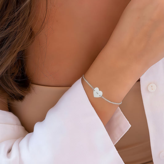 Woman wearing Sterling Silver Personalized Heart Bracelet. Fashionable gift for girls.