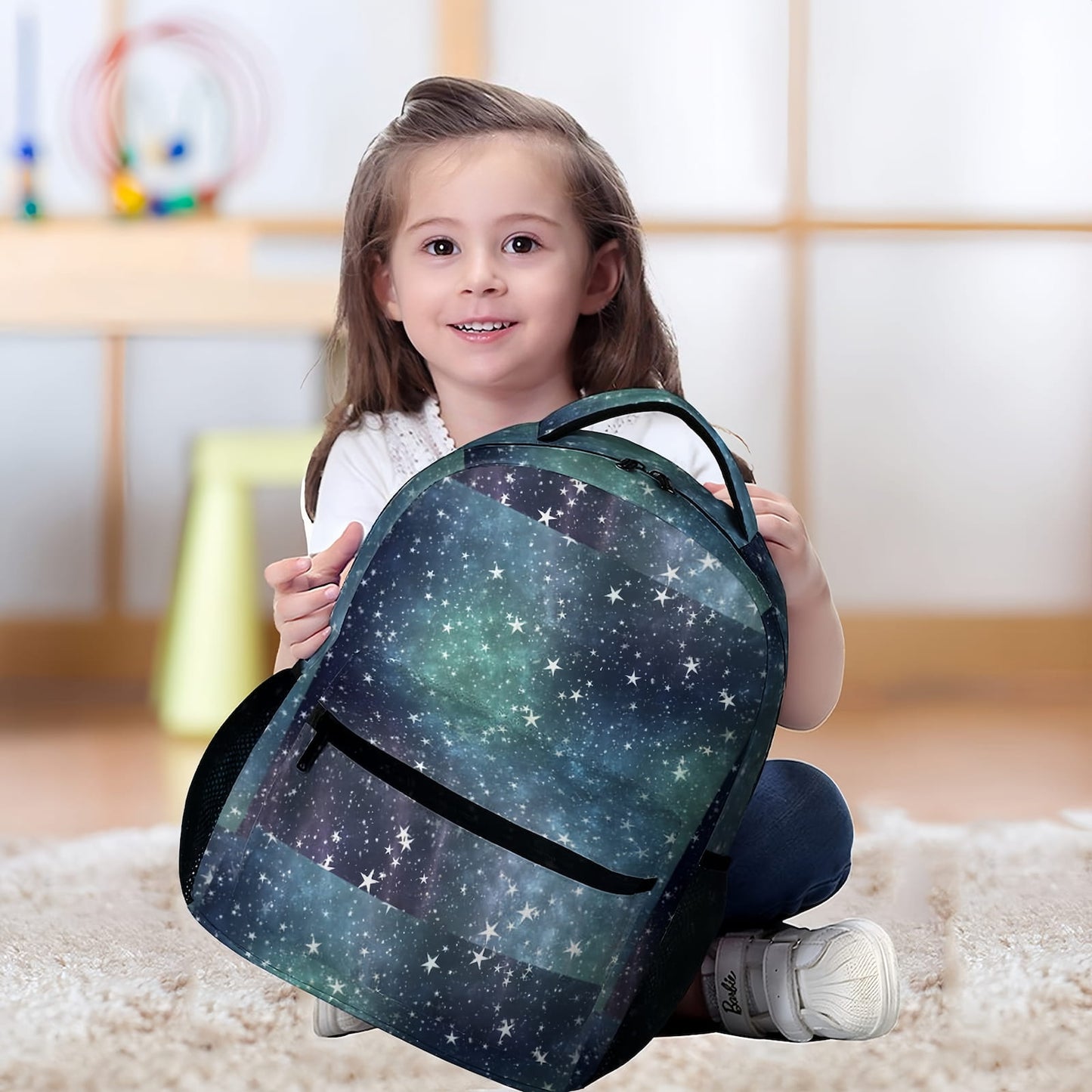 Young girl sitting with Personalized Star School Bag, showing real-life size.